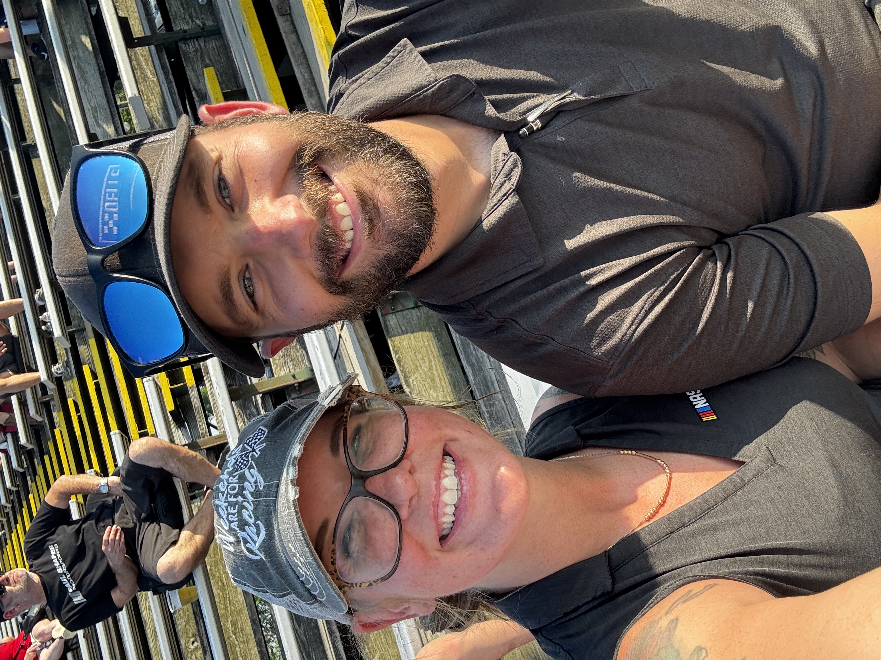 Evan Watz and Jamie Watz smiling together in racetrack grandstands — Jamie Watz and Evan Watz
